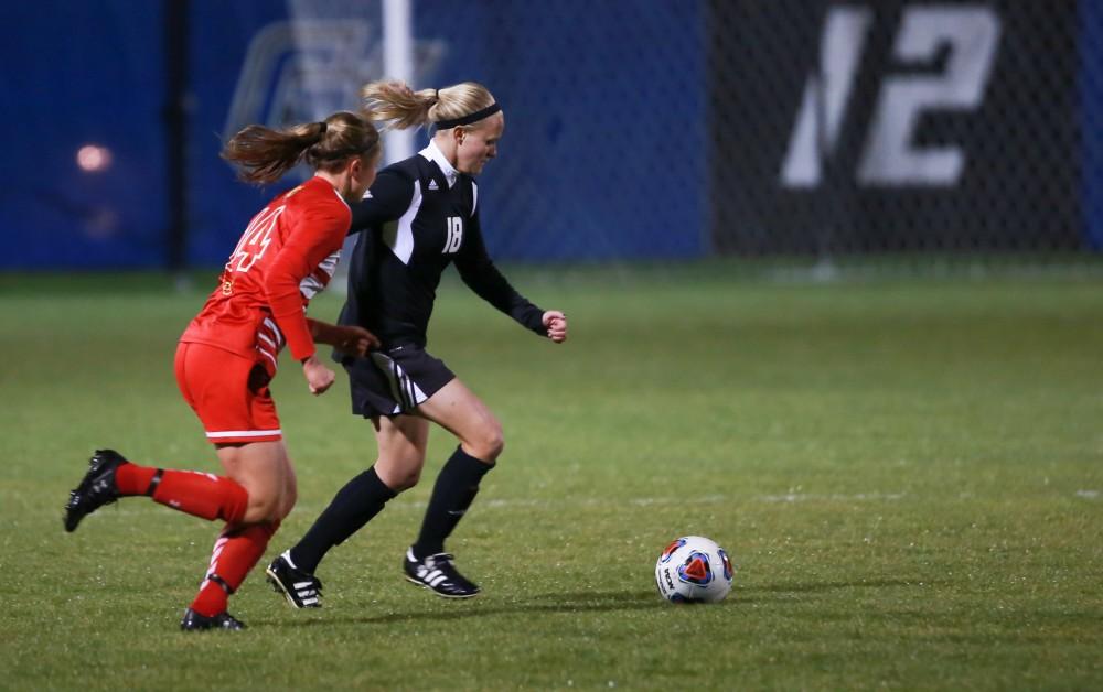 GVL / Kevin Sielaff - Maddison Reynolds (18) dribbles the ball up field.  The Lakers defeat the Bulldogs with a final score of 2-0 Oct. 30 in Allendale. Grand Valley will advance to the GLIAC tournament starting Nov. 3.