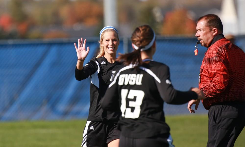 GVL / Kevin Sielaff - Katie Klunder (2) celebrates a goal with Marti Corby (13).  Grand Valley's women's soccer team squares off against Northern Michigan Oct. 18 and wins with a final score of 7-0.