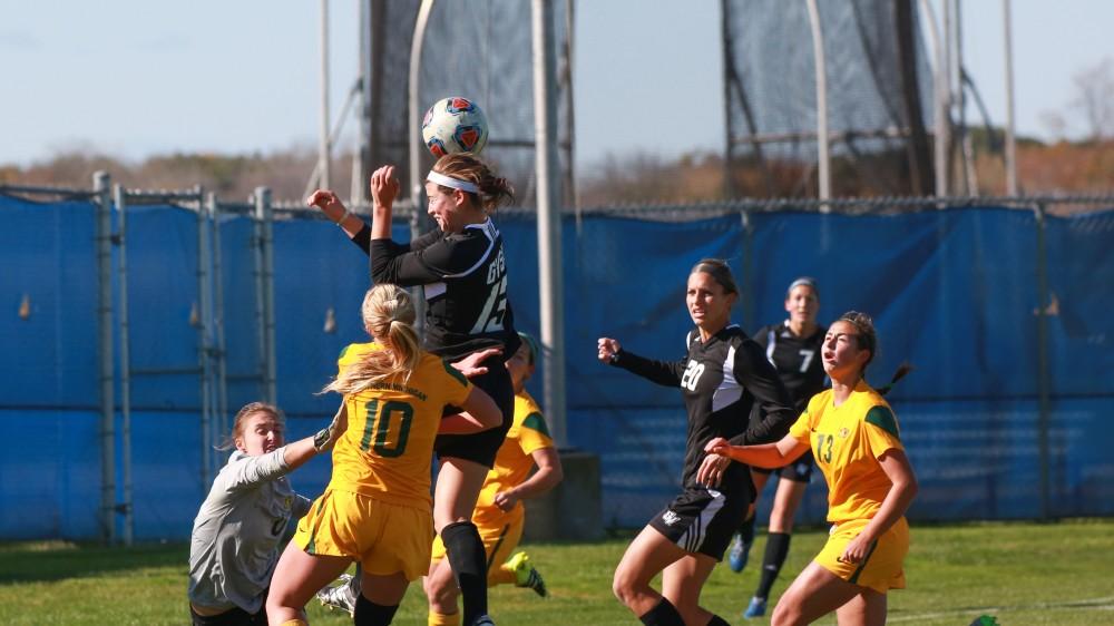 GVL / Kevin Sielaff - Marti Corby (13) rushes the net and attempts to head the ball into the goal.  Grand Valley's women's soccer team squares off against Northern Michigan Oct. 18 and wins with a final score of 7-0.