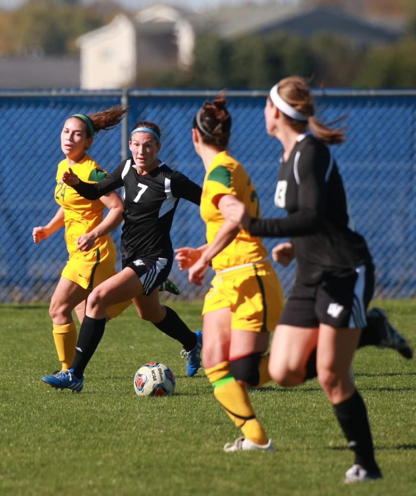 GVL / Kevin Sielaff - Clare Carlson (7) looks to pass the ball off to Marti Corby (13).  Grand Valley's women's soccer team squares off against Northern Michigan Oct. 18 and wins with a final score of 7-0.