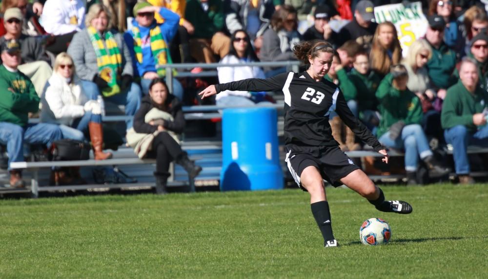 GVL / Kevin Sielaff -  Katy Woolley (23) sends the ball up field.  Grand Valley's women's soccer team squares off against Northern Michigan Oct. 18 and wins with a final score of 7-0.