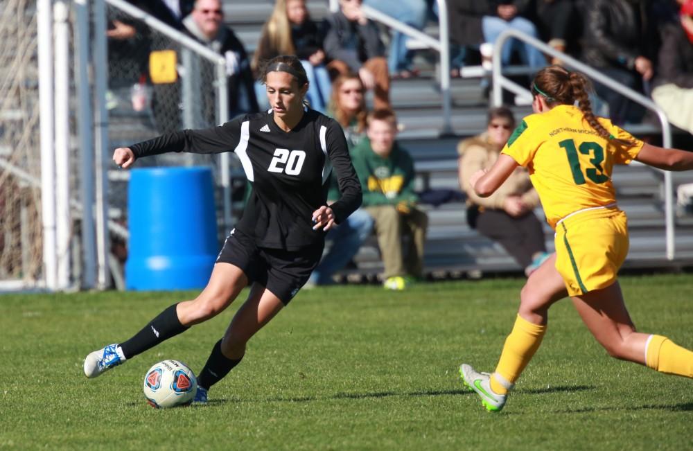 GVL / Kevin Sielaff - Gabriella Mencotti (20) pulls the ball back to set up Grand Valley's positioning.  Grand Valley's women's soccer team squares off against Northern Michigan Oct. 18 and wins with a final score of 7-0.