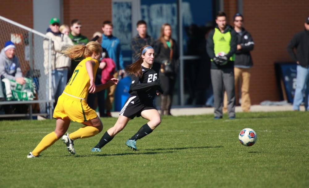 GVL / Kevin Sielaff - Lindsay Ebeling (26) tries to win the ball from Northern's midfielders.  Grand Valley's women's soccer team squares off against Northern Michigan Oct. 18 and wins with a final score of 7-0.