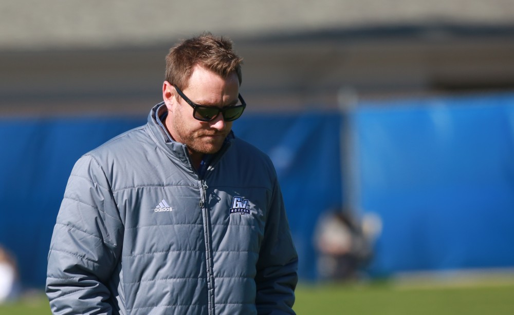 GVL / Kevin Sielaff - Head coach Jeff Hosler walks back to the bench after a huddle.  Grand Valley's women's soccer team squares off against Northern Michigan Oct. 18 and wins with a final score of 7-0.