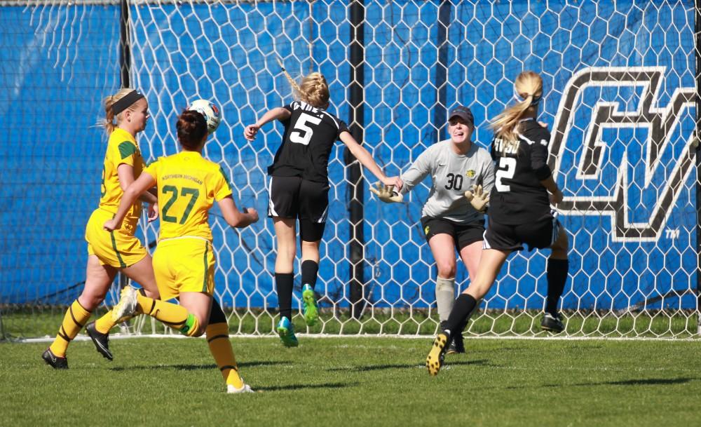 GVL / Kevin Sielaff - Kendra Stauffer (5) heads the ball into the back of the net.  Grand Valley's women's soccer team squares off against Northern Michigan Oct. 18 and wins with a final score of 7-0.