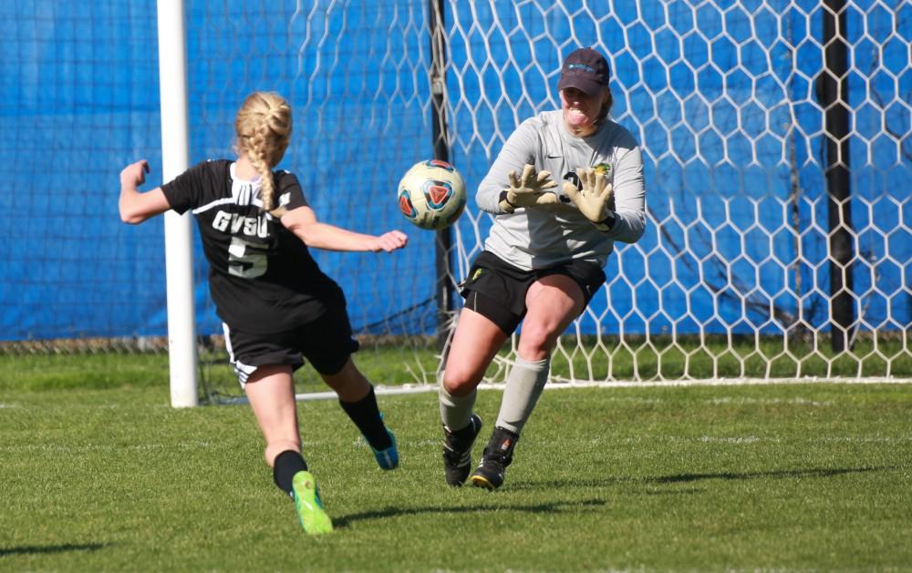 GVL / Kevin Sielaff - Kendra Stuaffer (5) continues her barrage on Northern's goaltender.  Grand Valley's women's soccer team squares off against Northern Michigan Oct. 18 and wins with a final score of 7-0.