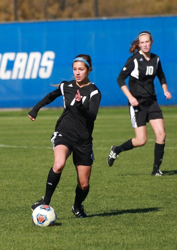 GVL / Kevin Sielaff - Mackenzie Fox (14) carries the ball down field.  Grand Valley's women's soccer team squares off against Northern Michigan Oct. 18 and wins with a final score of 7-0.