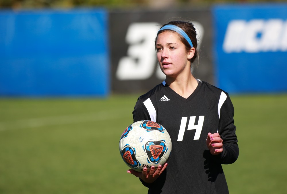 GVL / Kevin Sielaff - Mackenzie Fox (14) sets up to throw the ball into bounds.  Grand Valley's women's soccer team squares off against Northern Michigan Oct. 18 and wins with a final score of 7-0.