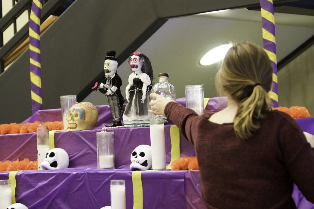 GVL / Sara Carte
Students place objects onto the alter in celebration of the Day of the Dead at the Honors college in Allendale’s Campus on Nov. 2.