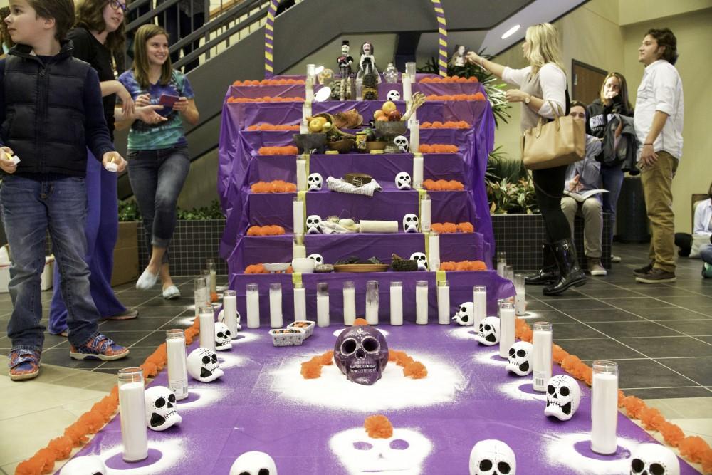 GVL / Sara Carte
Students and families gather around the alter, a Day of the Dead holiday tradition, for the celebration of  Day of the Dead at the Honors College on Allendale’s Campus on Nov. 2.