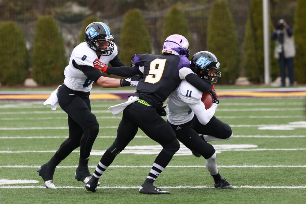 GVL / Kevin Sielaff - Nick Dodson (11) receives the ball, but is brought immediately to the ground.  Grand Valley defeats Ashland with a final score of 45-28 Nov. 22 at Ashland University.