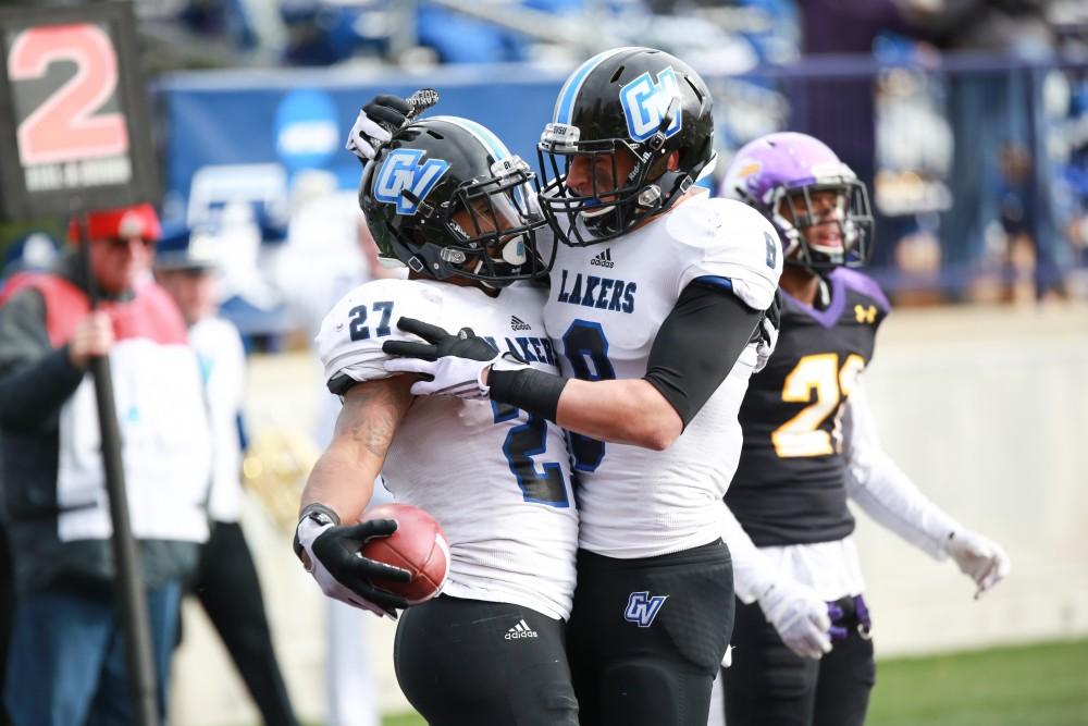 GVL / Kevin Sielaff -  Kirk Spencer (27) and Joe Robbins (8) celebrate a touchdown.  Grand Valley defeats Ashland with a final score of 45-28 Nov. 22 at Ashland University.