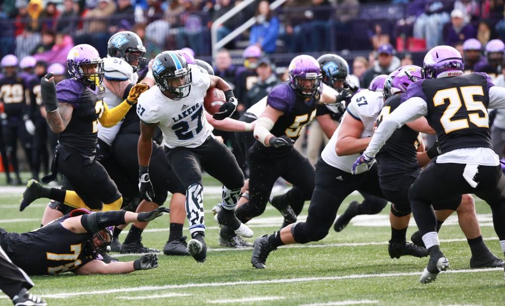 GVL / Kevin Sielaff - Kirk Spencer (27) jukes through Ashland's defense.  Grand Valley defeats Ashland with a final score of 45-28 Nov. 22 at Ashland University.