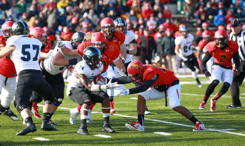 GVL / Kevin Sielaff - Marty Carter (34) swivels to evade a tackle.  Grand Valley defeats Ferris with a final score of 38-34 at Top Taggart Field Nov. 28 in Big Rapids, MI.