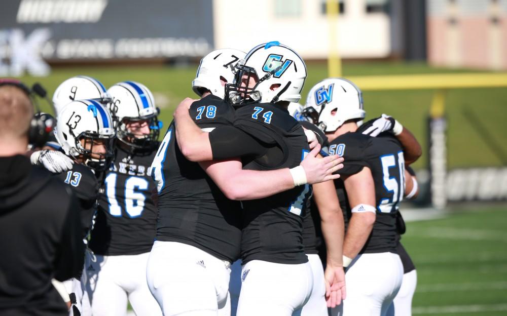 GVL / Kevin Sielaff - Seniors Jim Walsh (78) and Derek DeLuca (74) embrace before the match.  Grand Valley squares off against SVSU Nov. 14 in Allendale. The Lakers hold on and win with a final score of 24-17.