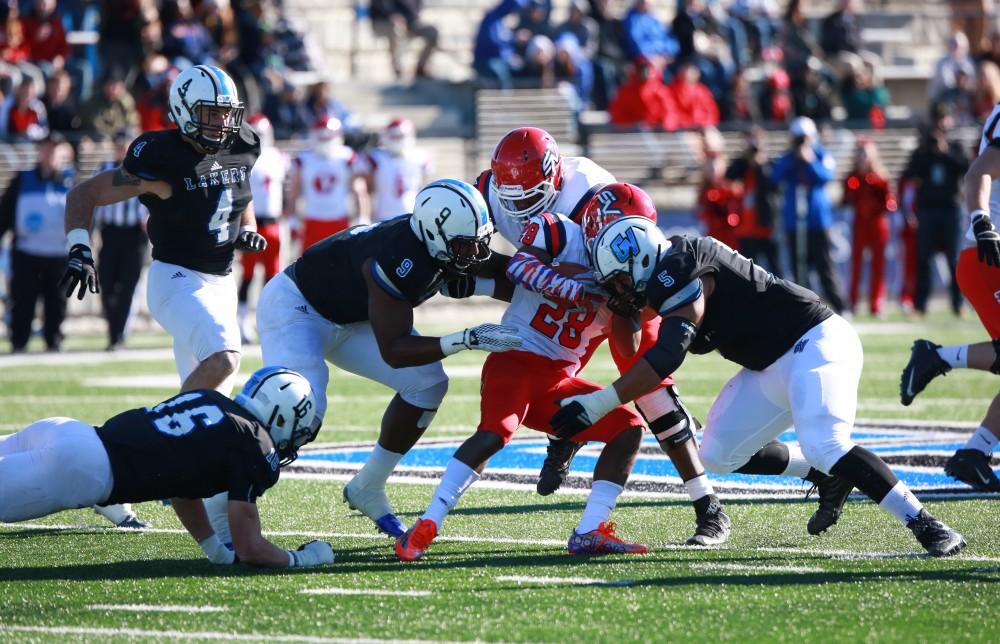 GVL / Kevin Sielaff - Matt Judon (9) and De'Ondre Hogan (5) tackle Sagniaw's Malik Washington (28).  Grand Valley squares off against SVSU Nov. 14 in Allendale. The Lakers hold on and win with a final score of 24-17.