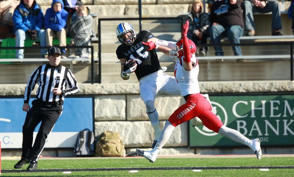 GVL / Kevin Sielaff - Jamie Potts (15) catches a pass that leads to the first Laker touchdown.  Grand Valley squares off against SVSU Nov. 14 in Allendale. The Lakers hold on and win with a final score of 24-17.