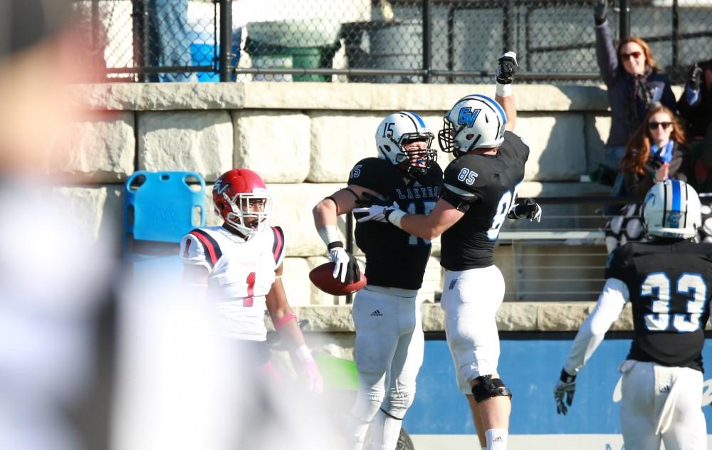 GVL / Kevin Sielaff - Jamie Potts (15) catches a pass that leads to the first Laker touchdown.  Grand Valley squares off against SVSU Nov. 14 in Allendale. The Lakers hold on and win with a final score of 24-17.