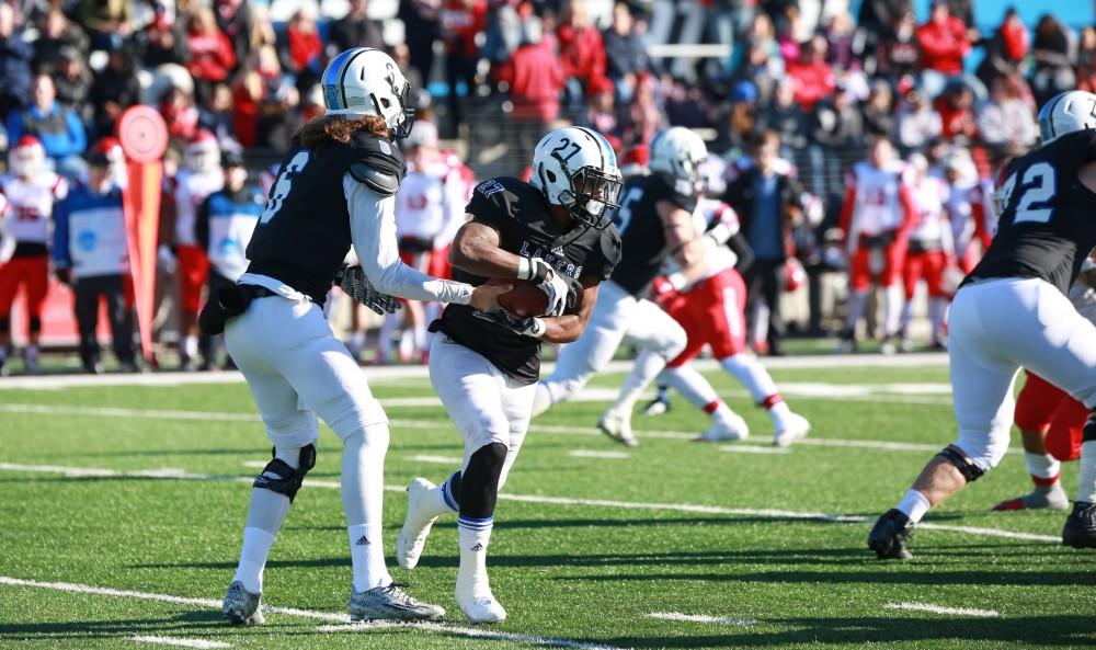 GVL / Kevin Sielaff - Bart Williams (6) hands the ball off to Kirk Spencer (27).  Grand Valley squares off against SVSU Nov. 14 in Allendale. The Lakers hold on and win with a final score of 24-17.