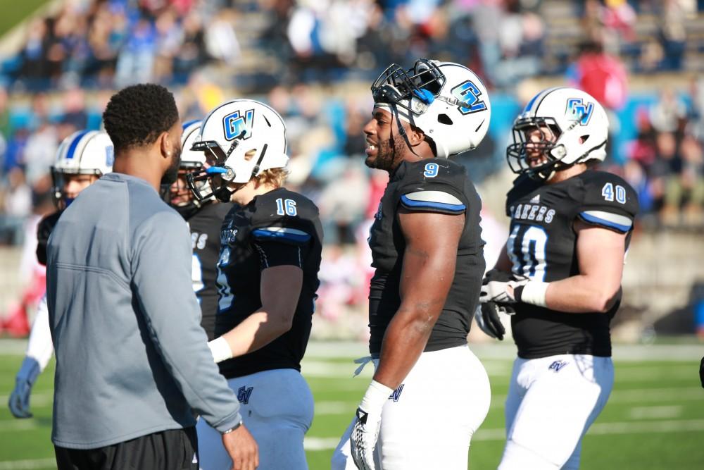 GVL / Kevin Sielaff - Matt Judon (9) talks with his teammates on the bench.  Grand Valley squares off against SVSU Nov. 14 in Allendale. The Lakers hold on and win with a final score of 24-17.