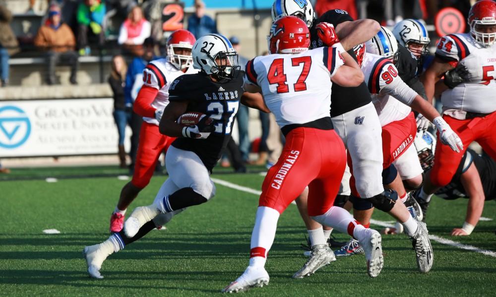 GVL / Kevin Sielaff - Kirk Spencer (27) seeks out a hole in the SVSU defense.  Grand Valley squares off against SVSU Nov. 14 in Allendale. The Lakers hold on and win with a final score of 24-17.