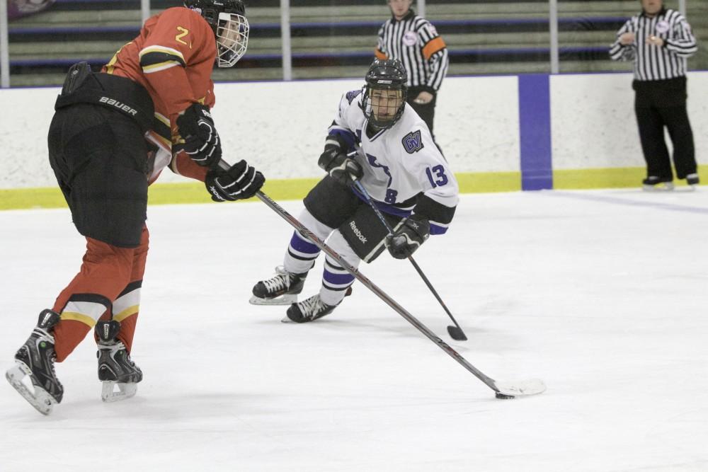 GVL / Sara Carte
Grand Valley’s DII Hockey player, Tony Russo, fights for the puck against Ferris State at Georgetown Ice Arena on Oct. 30.