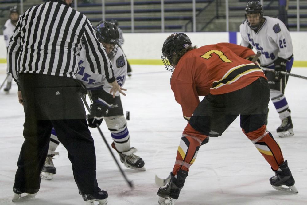 GVL / Sara Carte
Grand Valley’s DII Hockey player, Ales Ostrowski, fights for the puck against Ferris State at Georgetown Ice Arena on Oct. 30.