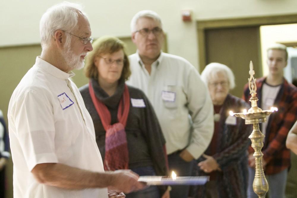 GVL / Sara Carte
People move the lit candle of the Aarti, a religious tradition, during the Interfaith Diwali Celebration at the Fountain Street Church on Oct. 30.