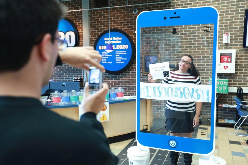 GVL / Kevin Sielaff - Samantha Przybylski holds a sign behind the "It's On Us" social media stand on Nov. 10 inside the Kirhof Center. 