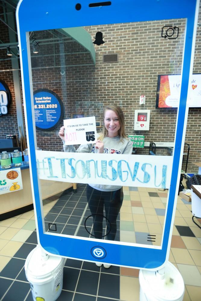 GVL / Kevin Sielaff - Claire Efting holds a sign behind the "It's On Us" social media stand on Nov. 10 inside the Kirhof Center. 