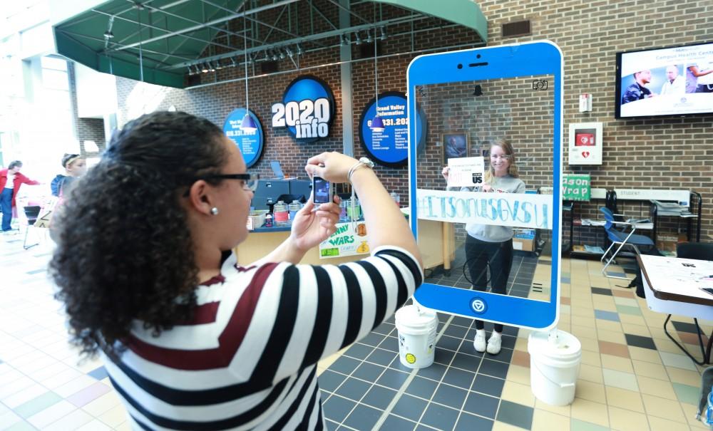 GVL / Kevin Sielaff - Claire Efting holds a sign behind the "It's On Us" social media stand on Nov. 10 inside the Kirhof Center.