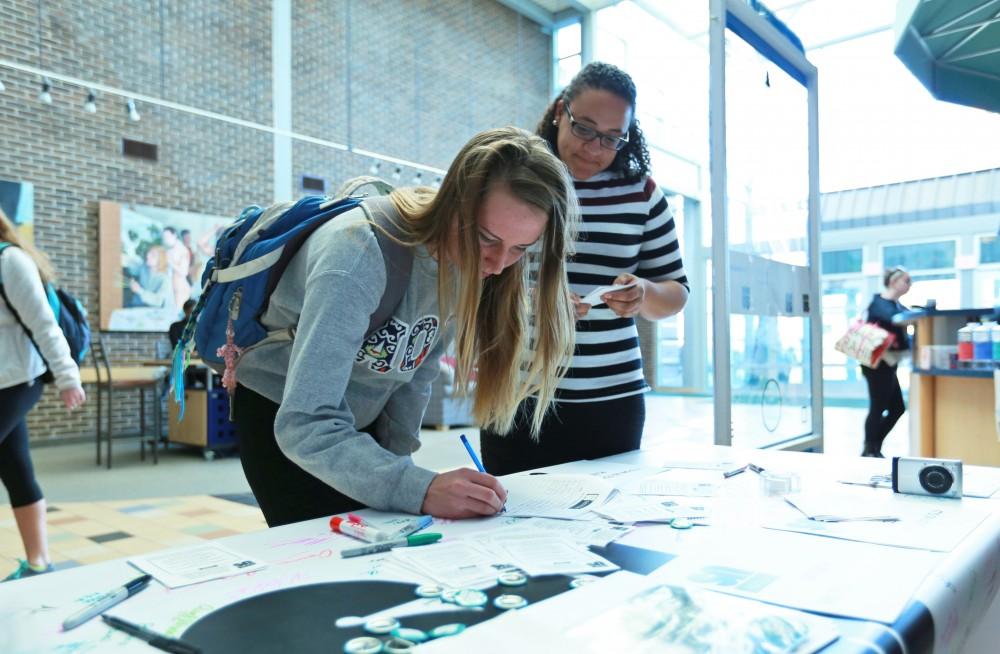 GVL / Kevin Sielaff - Claire Efting signs the "It's On Us" table on Nov. 10 inside the Kirhof Center. 