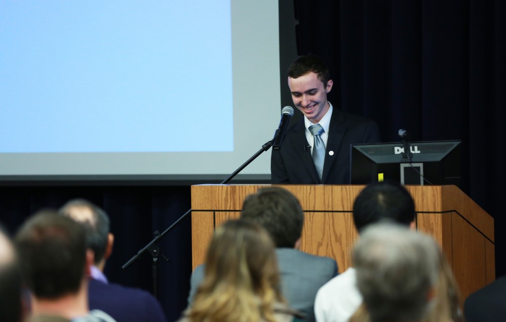 GVL / Kevin Sielaff - Sean O'Melia addresses the crowd and introduces Bart Merkle. Dean of students Bart Merkle speaks at student senate's Last Lecture Nov. 19 at Grand Valley's Mary Idema Pew Library.