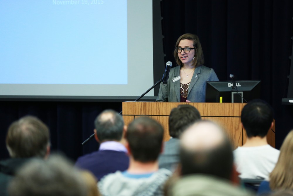 GVL / Kevin Sielaff - Maria Beelen addresses the crowd and introduces Bart Merkle. Dean of students Bart Merkle speaks at student senate's Last Lecture Nov. 19 at Grand Valley's Mary Idema Pew Library.