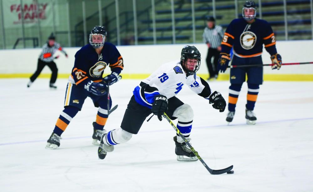 GVL / Kevin Sielaff - Collin Finkhouse (19) breaks away from the Rocket defense.  The Lakers square off against the Rockets from the University of Toledo Nov. 6 in Allendale.