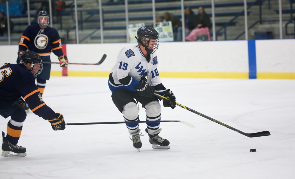 GVL / Kevin Sielaff - Collin Finkhouse (19) lines up a shot on net.  The Lakers square off against the Rockets from the University of Toledo Nov. 6 in Allendale.