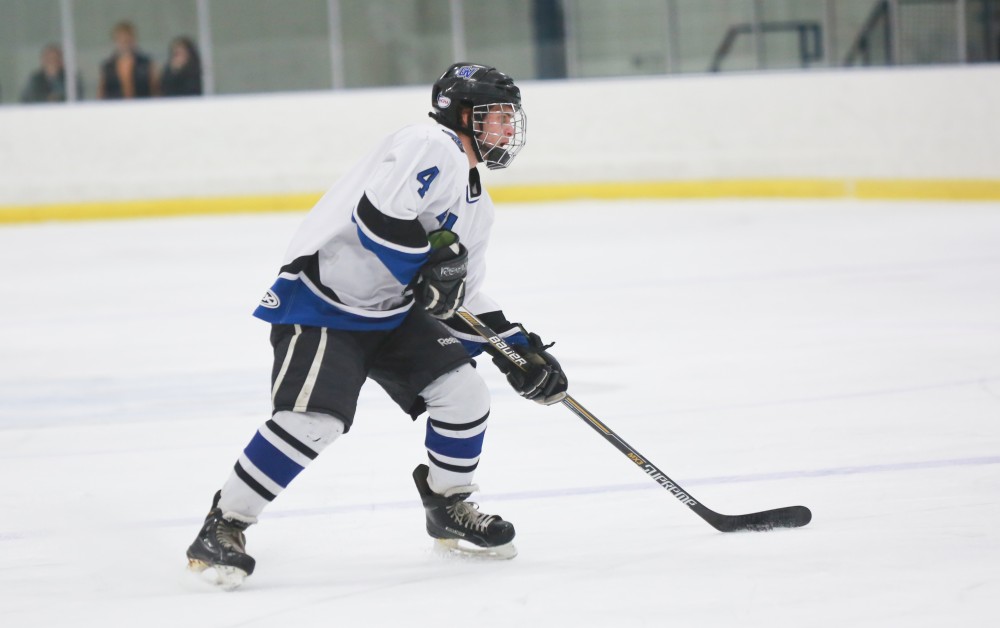 GVL / Kevin Sielaff - Tom Lusynski (4) sets up a Grand Valley power play.  The Lakers square off against the Rockets from the University of Toledo Nov. 6 in Allendale.