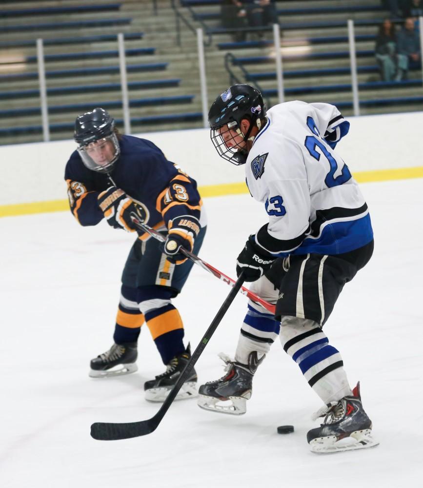 GVL / Kevin Sielaff - Alex Ostrowski (23) slips the puck between his legs.  The Lakers square off against the Rockets from the University of Toledo Nov. 6 in Allendale.