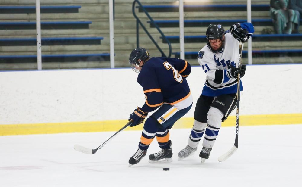 GVL / Kevin Sielaff - Iam Hamilton (21) evades the defense with a toe drag.  The Lakers square off against the Rockets from the University of Toledo Nov. 6 in Allendale.