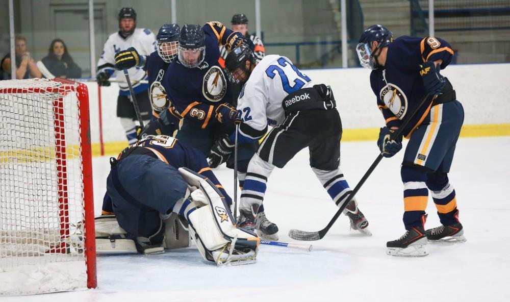 GVL / Kevin Sielaff - Zac Strain (22) tries to force the puck into the opposing net, but is unsuccessful.  The Lakers square off against the Rockets from the University of Toledo Nov. 6 in Allendale.