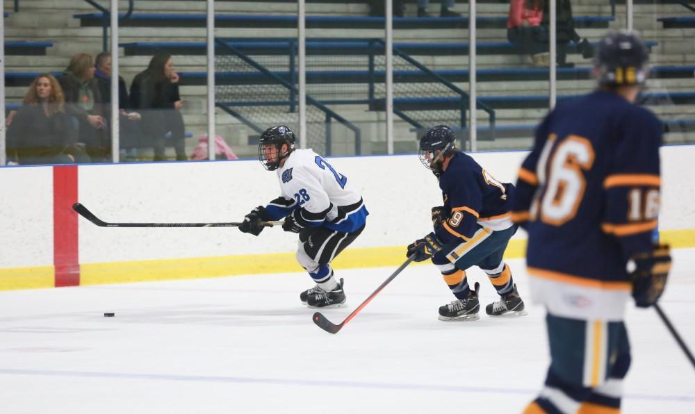 GVL / Kevin Sielaff - Lucas Little (28) moves the puck in the neutral zone.  The Lakers square off against the Rockets from the University of Toledo Nov. 6 in Allendale.