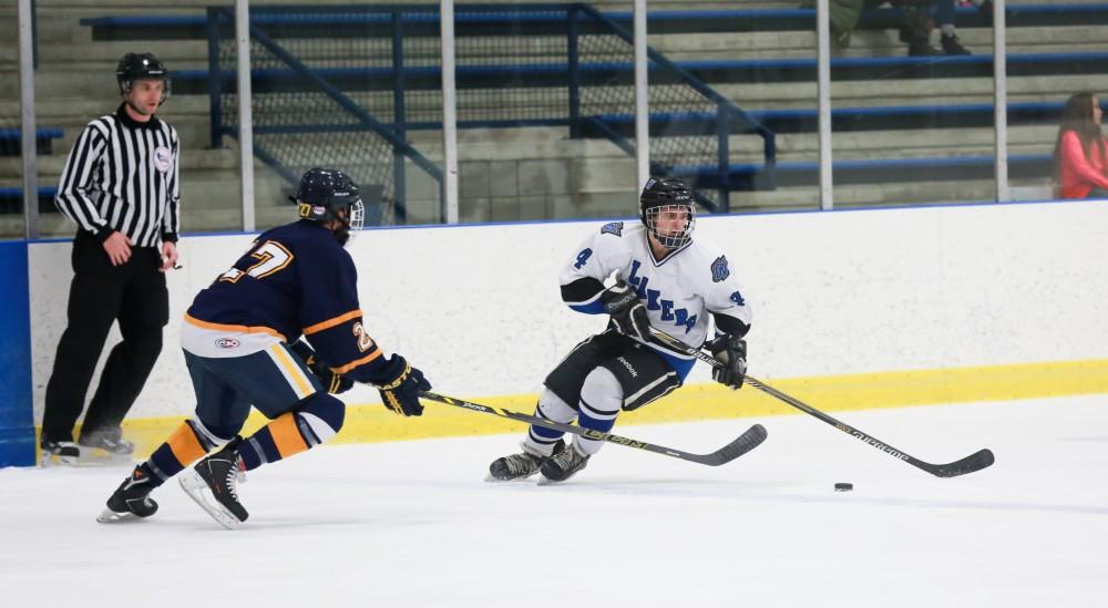 GVL / Kevin Sielaff - Tom Lusynski (4) pulls the puck back to try and set up a play.  The Lakers square off against the Rockets from the University of Toledo Nov. 6 in Allendale.