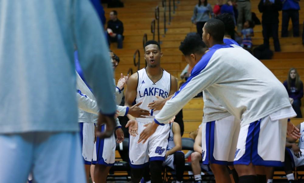 GVL / Kevin Sielaff - Aaron Hayes (1) runs onto the court with his fellow starters before the match.  The Laker basketball squad defeats Grace Bible College with a final score of 83-57 Nov. 23 in the fieldhouse arena.