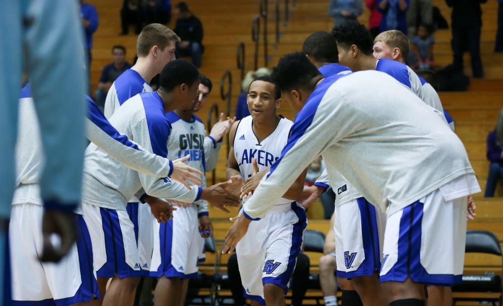 GVL / Kevin Sielaff - Myles Miller (12) joins the starters on the court before the match.  The Laker basketball squad defeats Grace Bible College with a final score of 83-57 Nov. 23 in the fieldhouse arena.