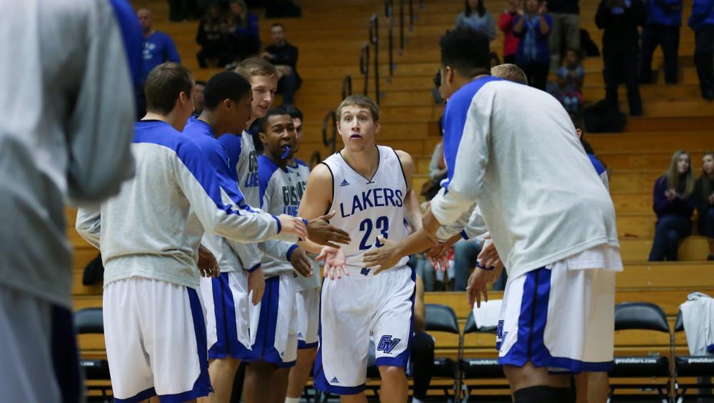 GVL / Kevin Sielaff - Luke Ryskamp (23) joins the starters on the court before the start of the match.  The Laker basketball squad defeats Grace Bible College with a final score of 83-57 Nov. 23 in the fieldhouse arena.