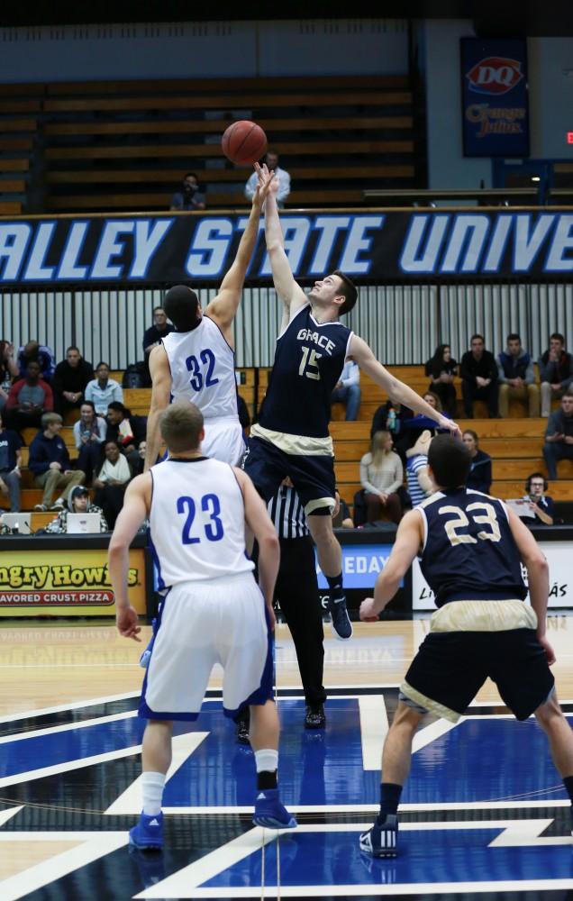 GVL / Kevin Sielaff - Ricardo Carbajal (32) goes up for the tip at the start of the match.  The Laker basketball squad defeats Grace Bible College with a final score of 83-57 Nov. 23 in the fieldhouse arena.