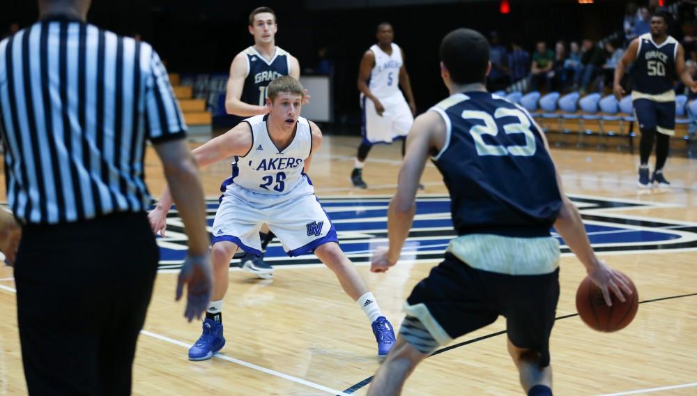 GVL / Kevin Sielaff -  Luke Ryskamp (23) back-peddles to defend an attack by Grace Bible.  The Laker basketball squad defeats Grace Bible College with a final score of 83-57 Nov. 23 in the fieldhouse arena.