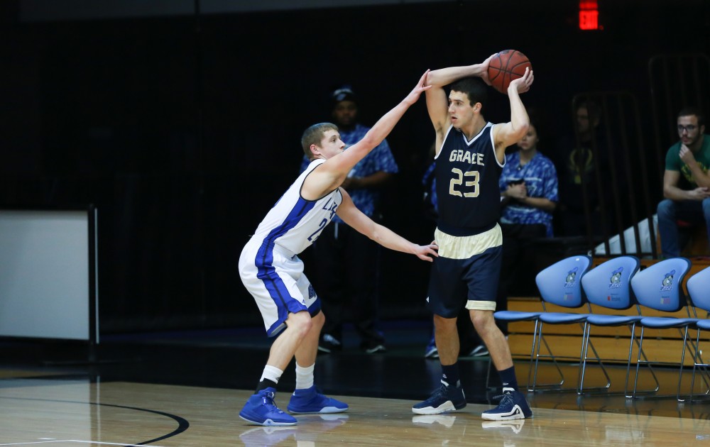 GVL / Kevin Sielaff - Luke Ryskamp (23) defends a Grace Bible point guard.  The Laker basketball squad defeats Grace Bible College with a final score of 83-57 Nov. 23 in the fieldhouse arena.