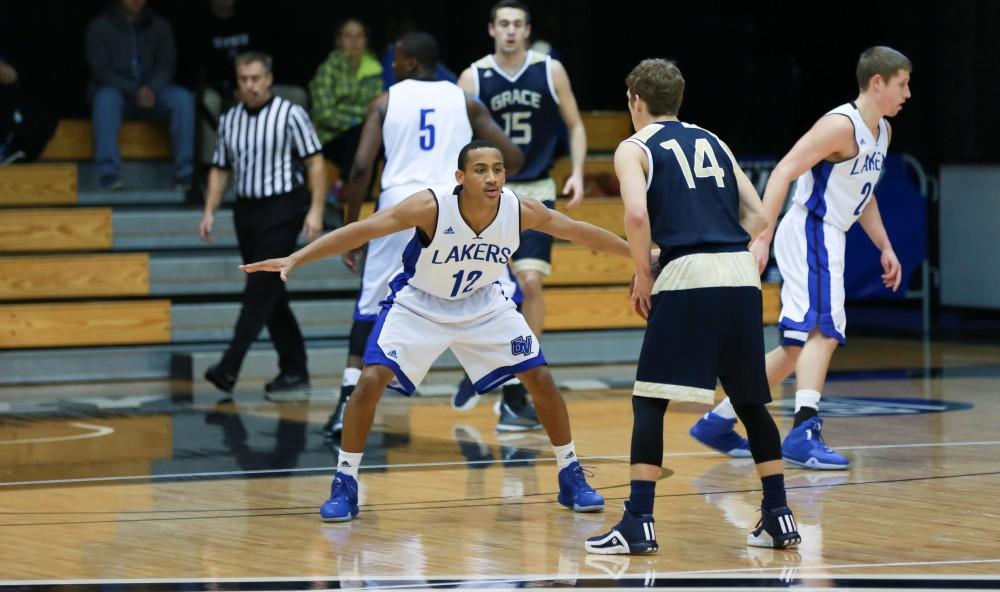 GVL / Kevin Sielaff - Myles Miller (12) defends a Grace Bible point guard.  The Laker basketball squad defeats Grace Bible College with a final score of 83-57 Nov. 23 in the fieldhouse arena.