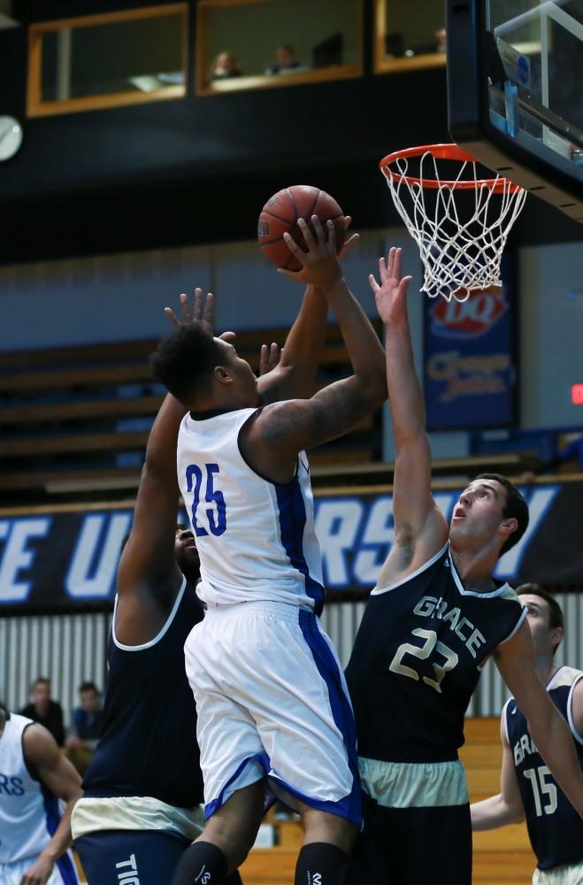 GVL / Kevin Sielaff - Chaz Rollins (25) drives the ball hard to the boards.  The Laker basketball squad defeats Grace Bible College with a final score of 83-57 Nov. 23 in the fieldhouse arena.